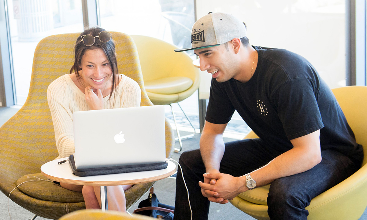 Two students looking at a computer